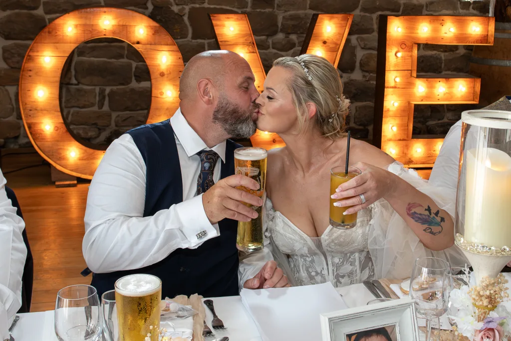 Bride and Groom share a kiss at Danby Castle Barn