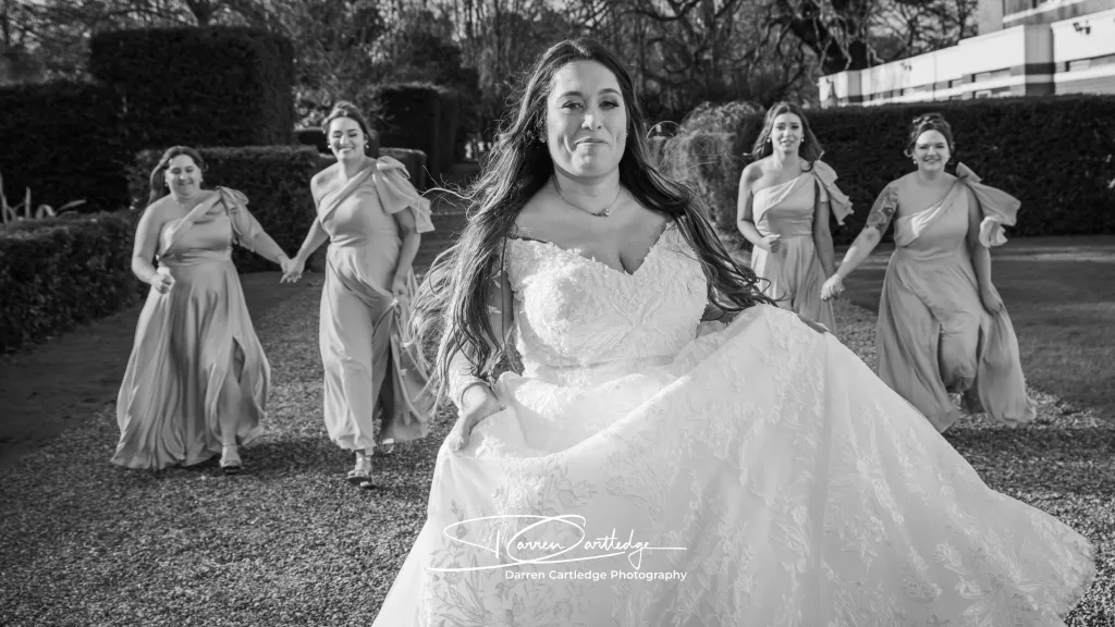 Bride being chased by bridesmaids at a wedding at Bawtry Hall, South Yorkshire