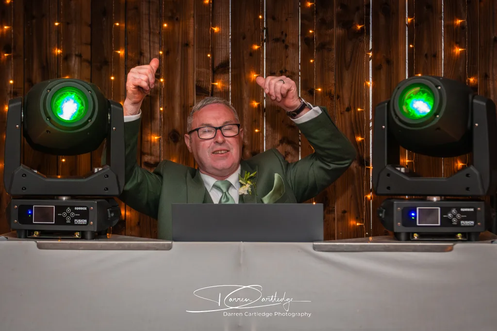 Best man taking over the DJ booth at Howard Court during a Yorkshire wedding