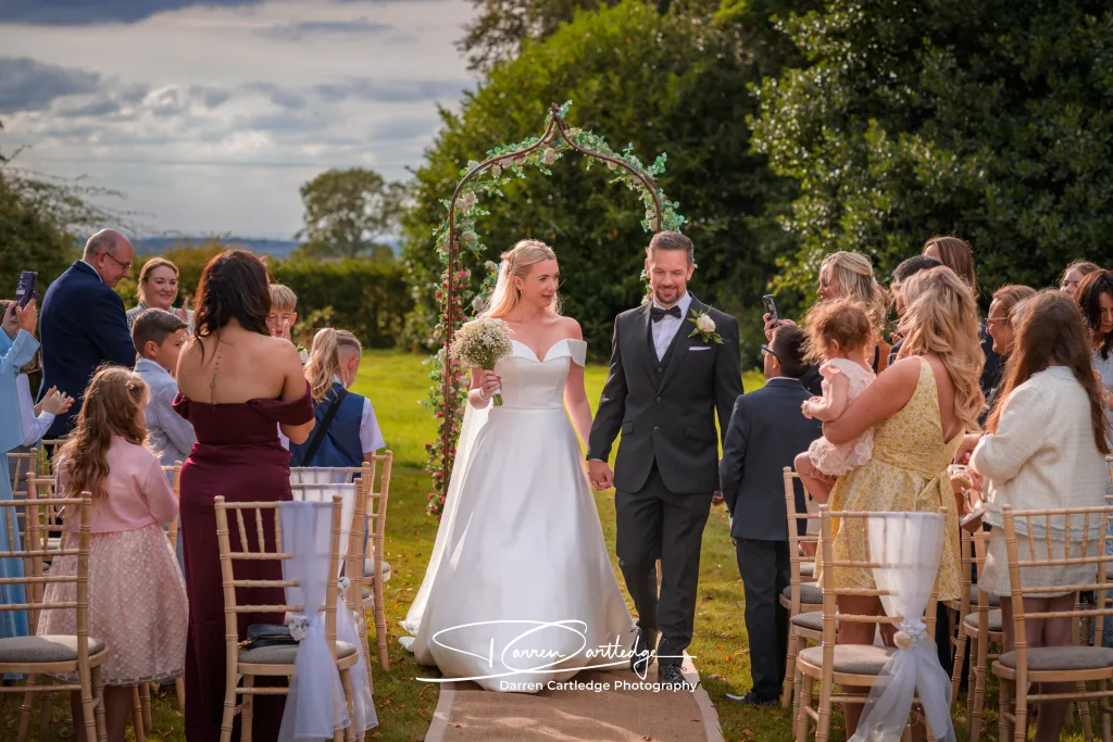 Bride and groom exiting the wedding ceremony as newlyweds at a Yorkshire wedding