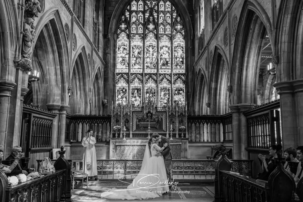Bride and groom kissing during a church wedding ceremony in East Yorkshire