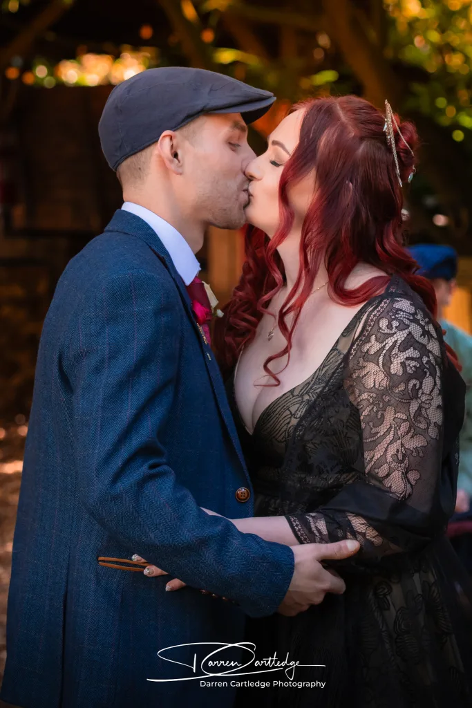 Bride and groom kissing during a woodland wedding ceremony at a Yorkshire wedding