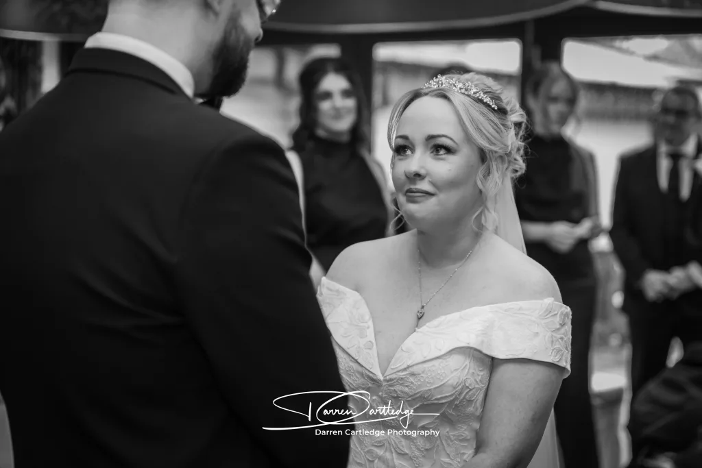 Bride subtly smiling at groom during the wedding ceremony at a Yorkshire wedding