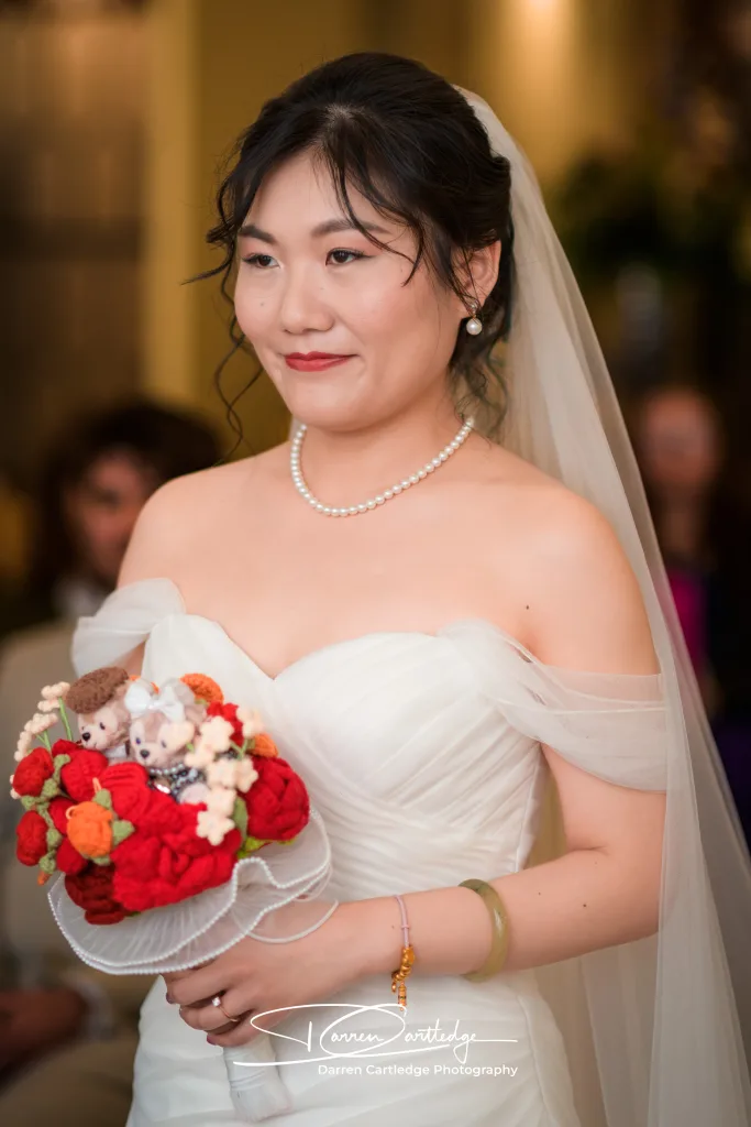 Candid moment of bride smiling during the wedding ceremony at a Hull wedding