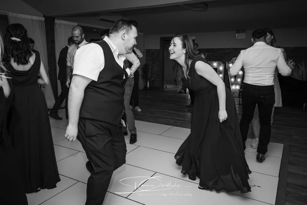 Bridesmaid and groomsman dancing at Willerby Barn during a Yorkshire wedding