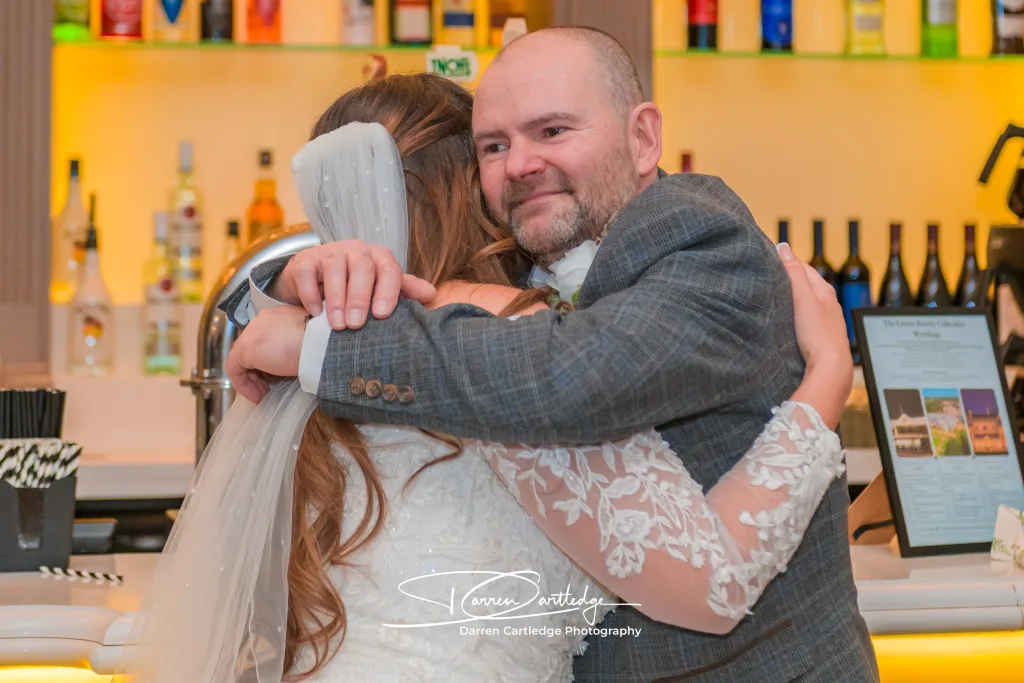 Candid moment of bride hugging her father during a Yorkshire wedding
