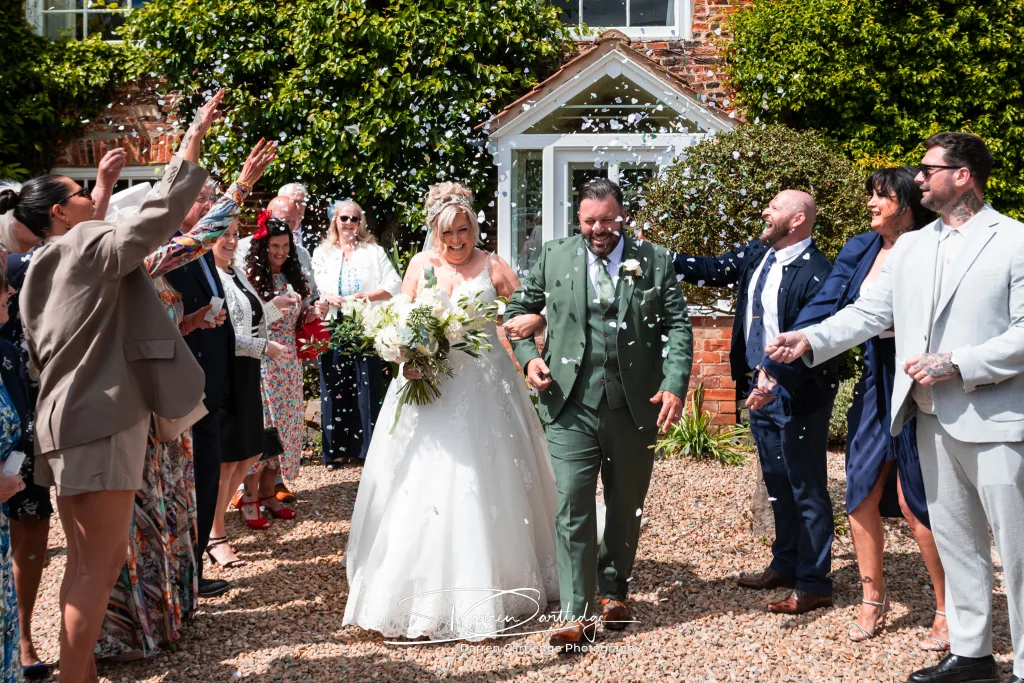 Bride and groom surrounded by confetti at Howard Court during a Yorkshire wedding