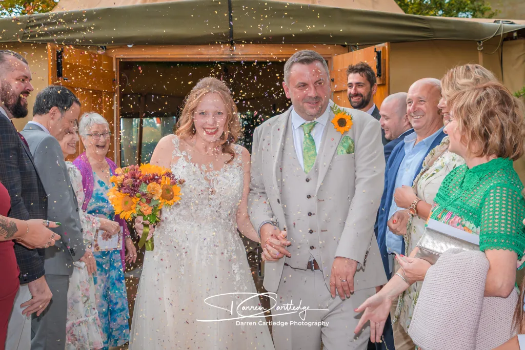 Bride and groom surrounded by confetti at Cedar Court Harrogate during a Yorkshire wedding