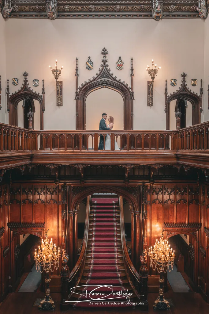 Bride and groom on the grand stairs at Allerton Castle during a Yorkshire wedding