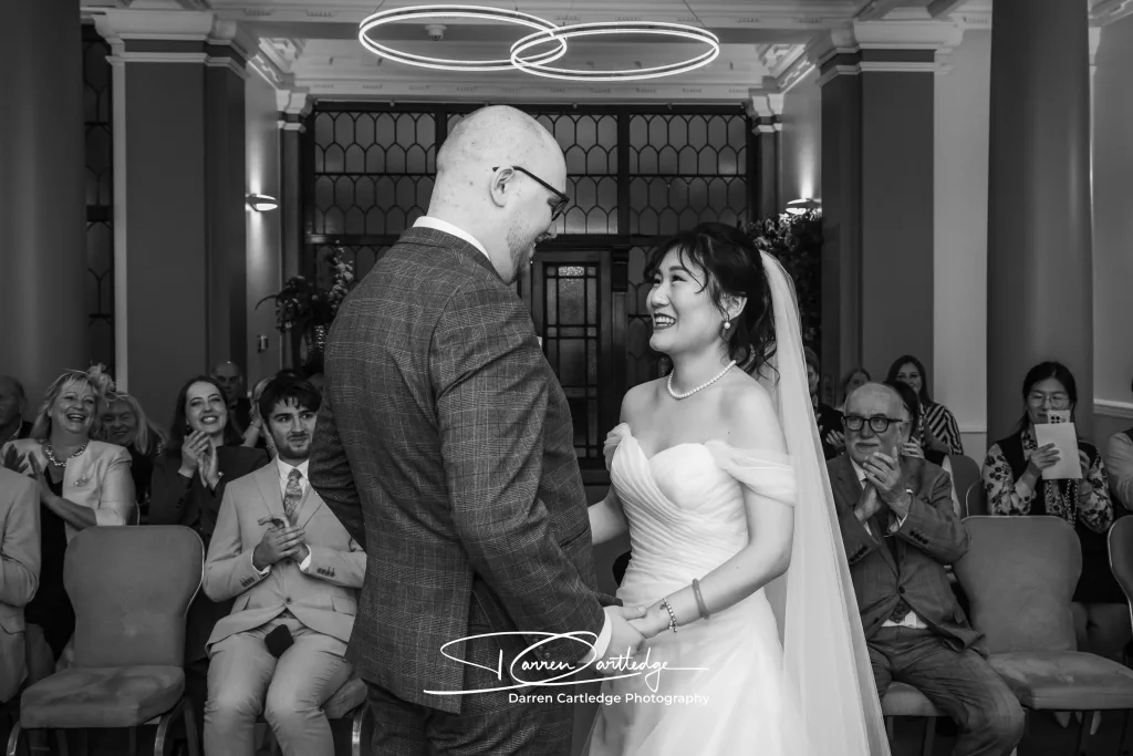 Bride and groom sharing big smiles as the wedding ceremony comes to a close at a Yorkshire wedding