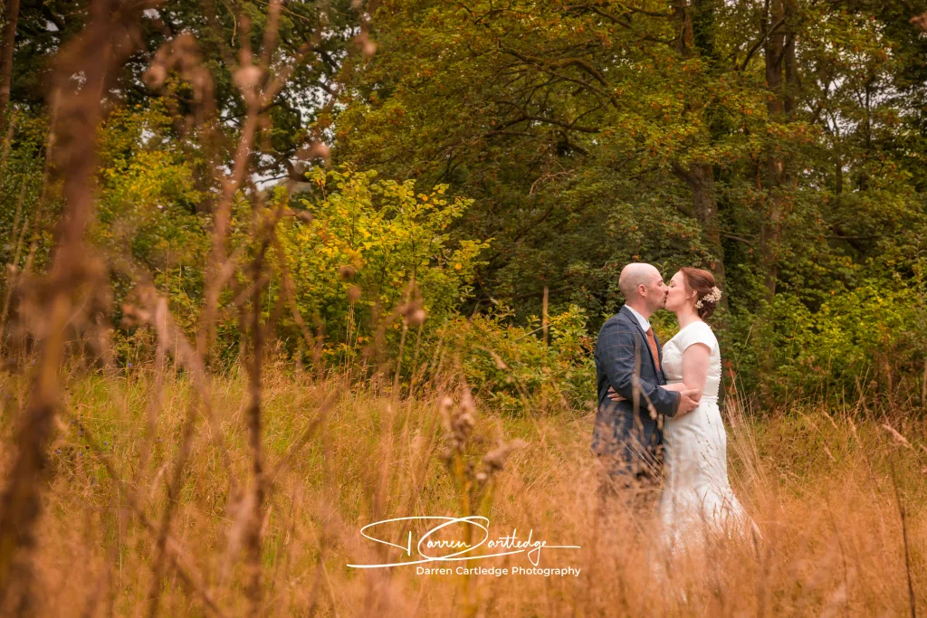 Bride and groom kissing in the grounds of Hackness Grange during a Yorkshire wedding