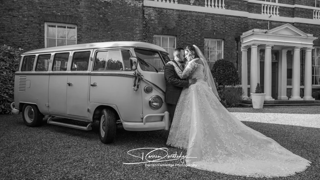 Relaxed couple portrait with a camper van at Bawtry Hall during a Yorkshire wedding