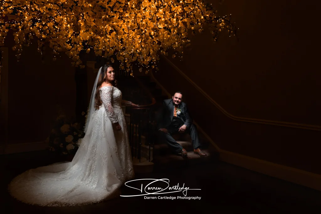 Leeann and Johnathan sharing a quiet moment on the grand staircase at Bawtry Hall, South Yorkshire