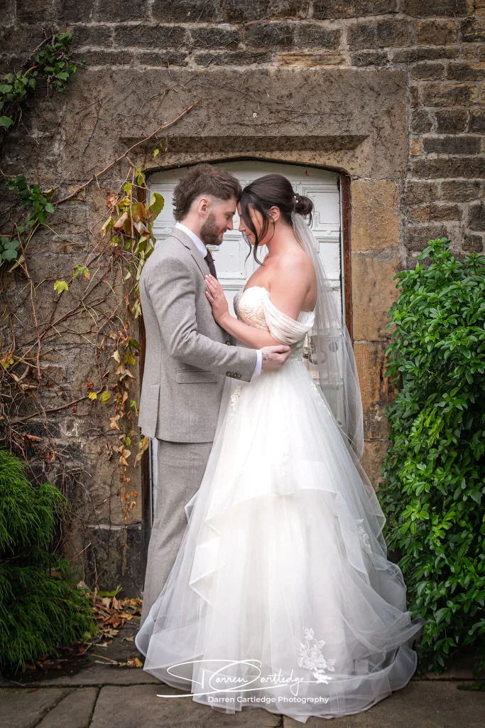 Bride and groom sharing a tender embrace at Whitley Hall during a Yorkshire wedding
