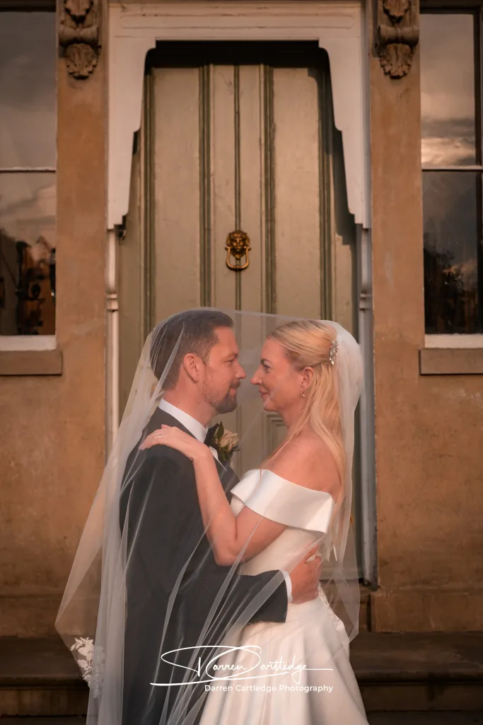 Bride and groom sharing a moment under the veil at Cleatham Hall during a Lincolnshire wedding