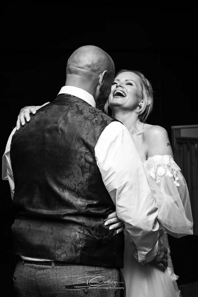 Bride and groom sharing a laugh during their first dance at Danby Castle, Yorkshire