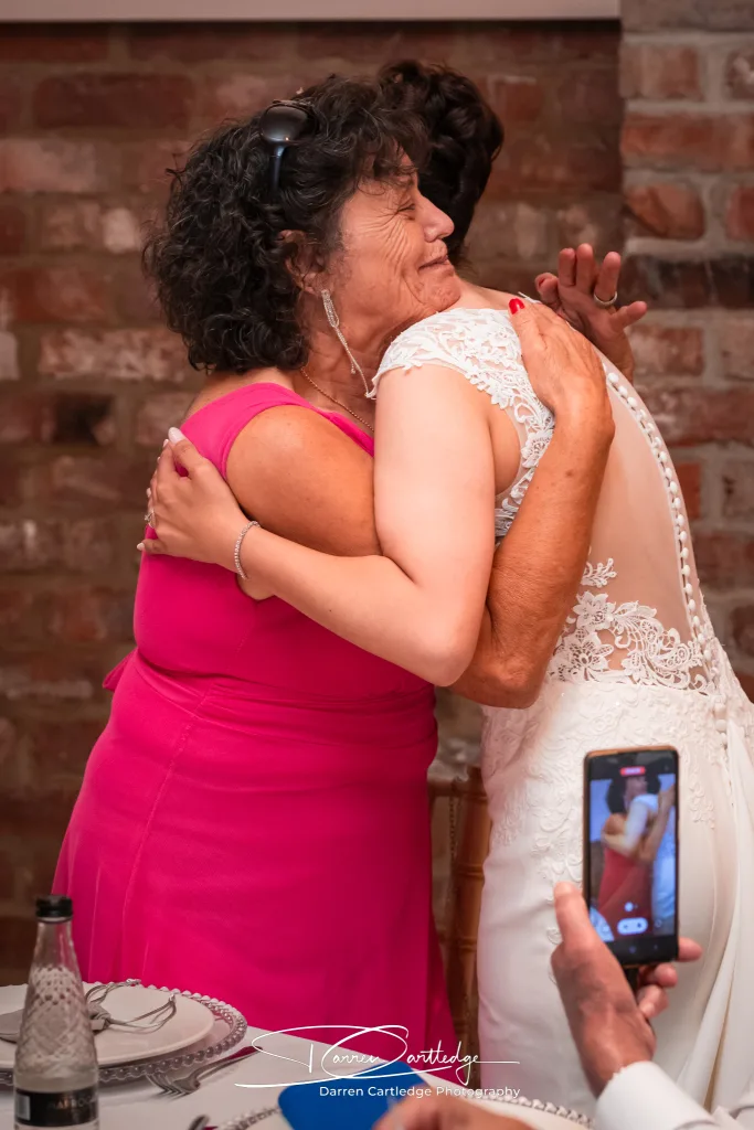 Grandmother hugging the bride at Willerby Barn during a Yorkshire wedding