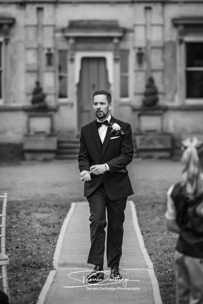 Groom making his entrance during the wedding ceremony at a Yorkshire wedding
