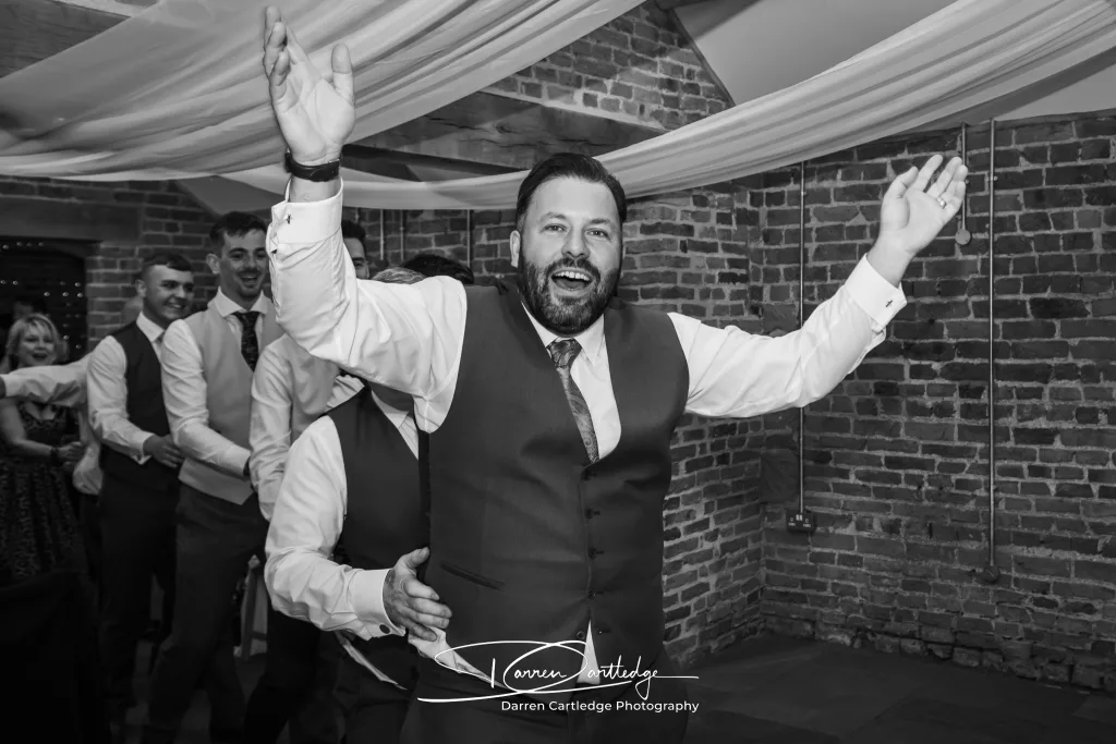 Groom leading a conga line at Howard Court during a Yorkshire wedding