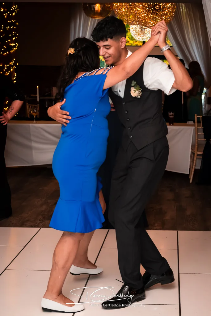 Groomsman dancing with the mother of the bride at Willerby Barn during a Yorkshire wedding