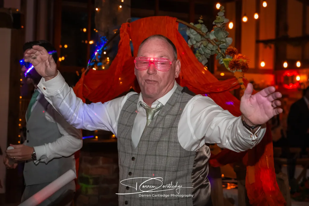 Wedding guest wearing funky glasses on the dancefloor during a Yorkshire wedding