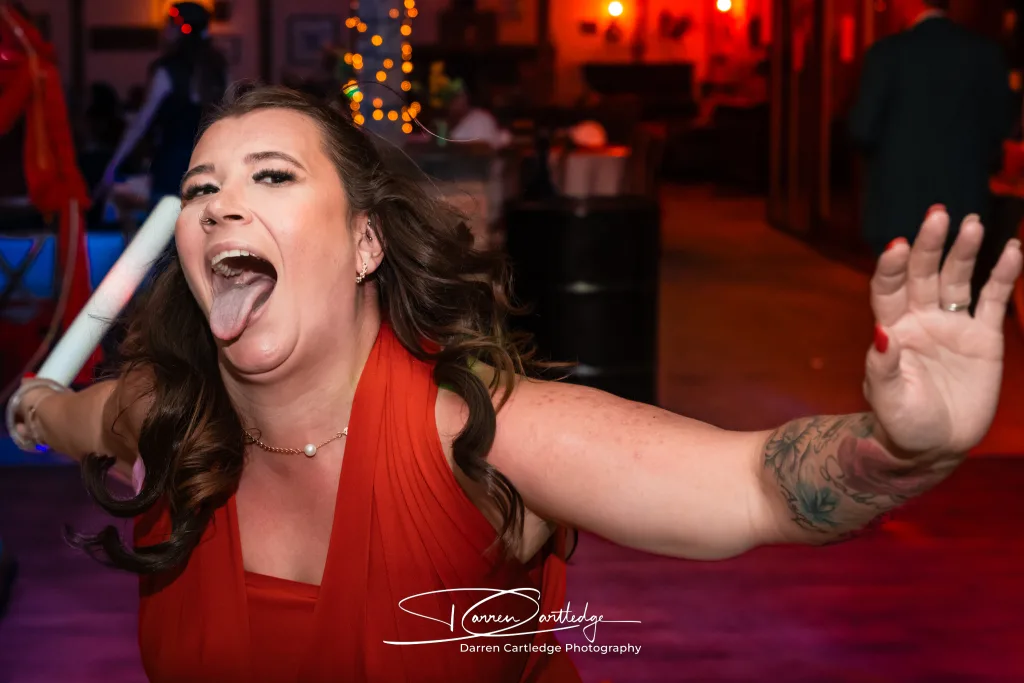 Wedding guest sticking their tongue out on the dancefloor at Clapham Holme Farm during an East Yorkshire wedding