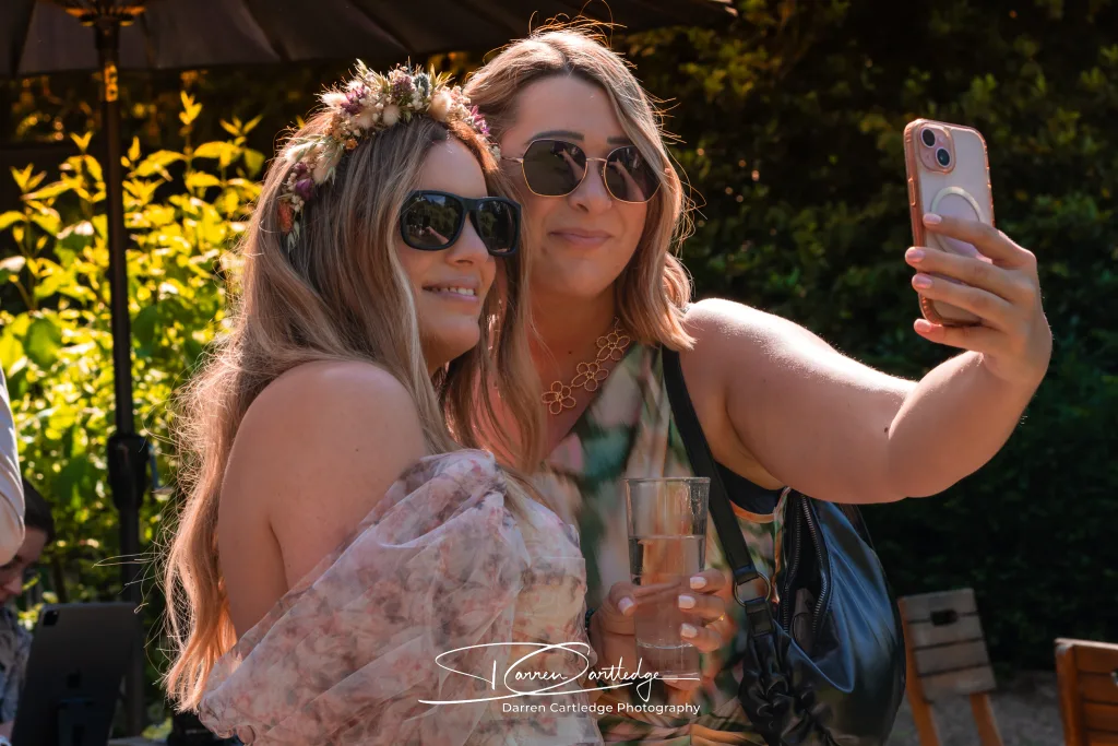 Wedding guest taking a selfie with the bride at The Old Deanery in Ripon during a Yorkshire wedding