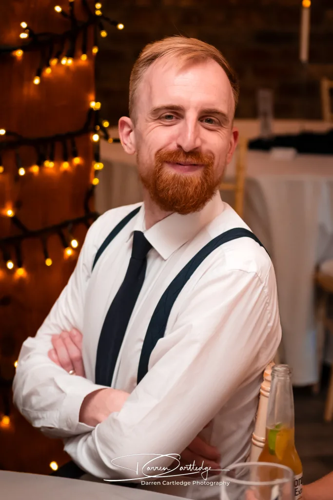 Wedding guest smiling at the camera at Willerby Barn during a Yorkshire wedding