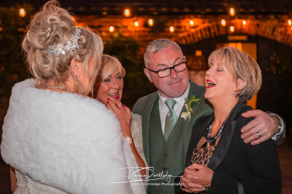Wedding guests chatting under fairy lights at Howard Court during a Yorkshire wedding