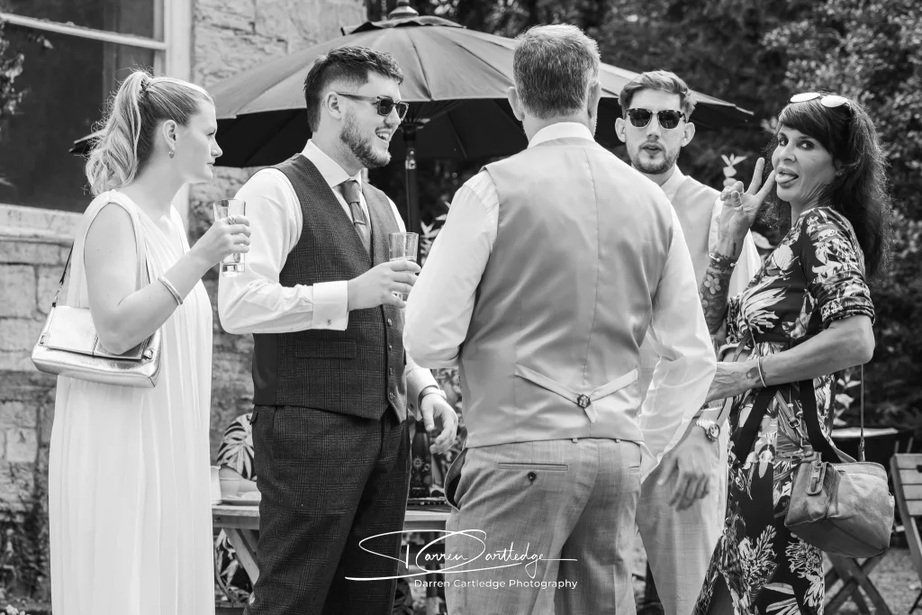 Wedding guests noticing the camera at The Old Deanery in Ripon during a Yorkshire wedding