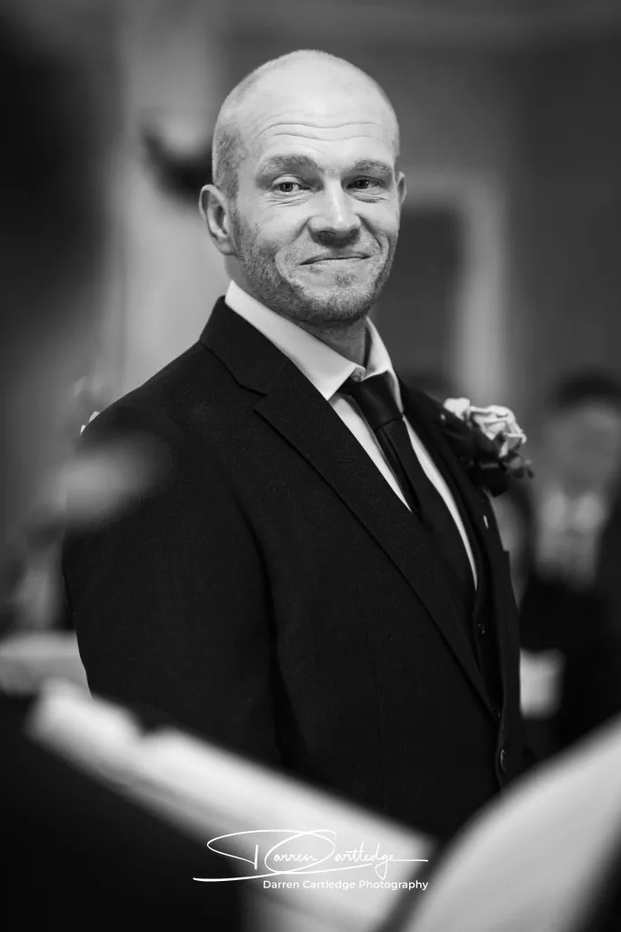 Happy groom smiling during the wedding ceremony at a Yorkshire wedding