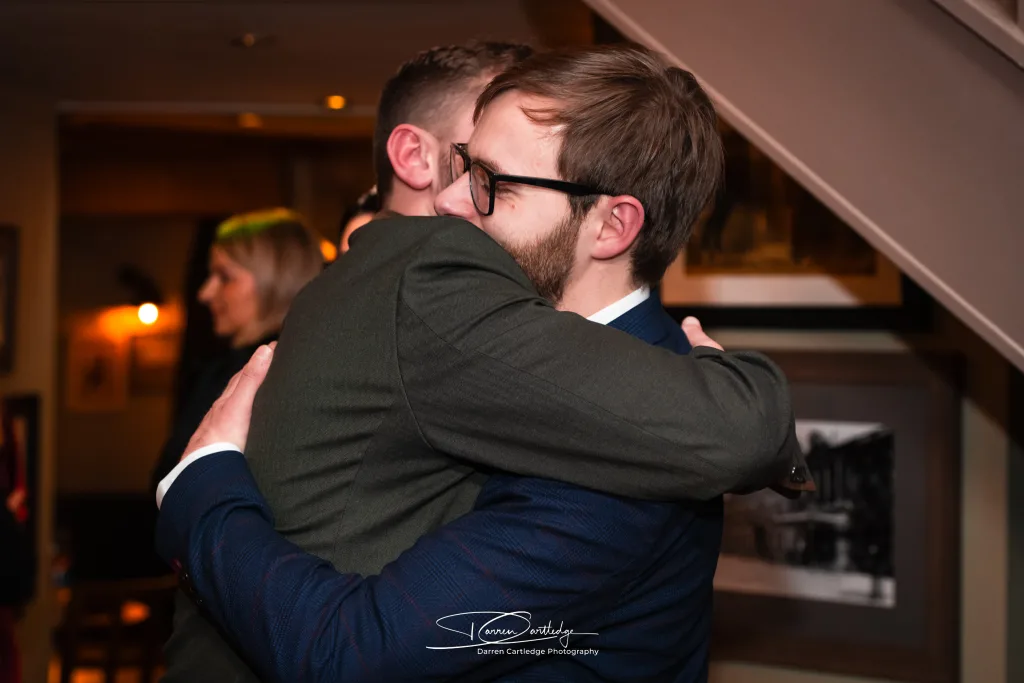 Guest hugging the groom during a wedding at The Tempest Arms, Yorkshire