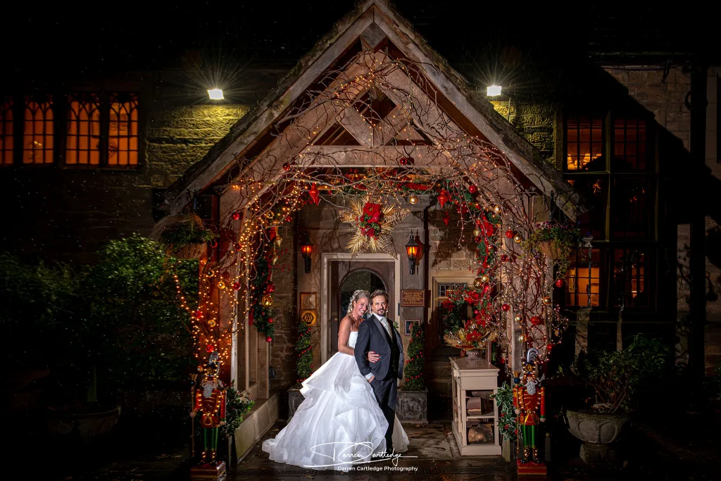 Couple portrait under an arch during a winter wedding at Whitley Hall, South Yorkshire