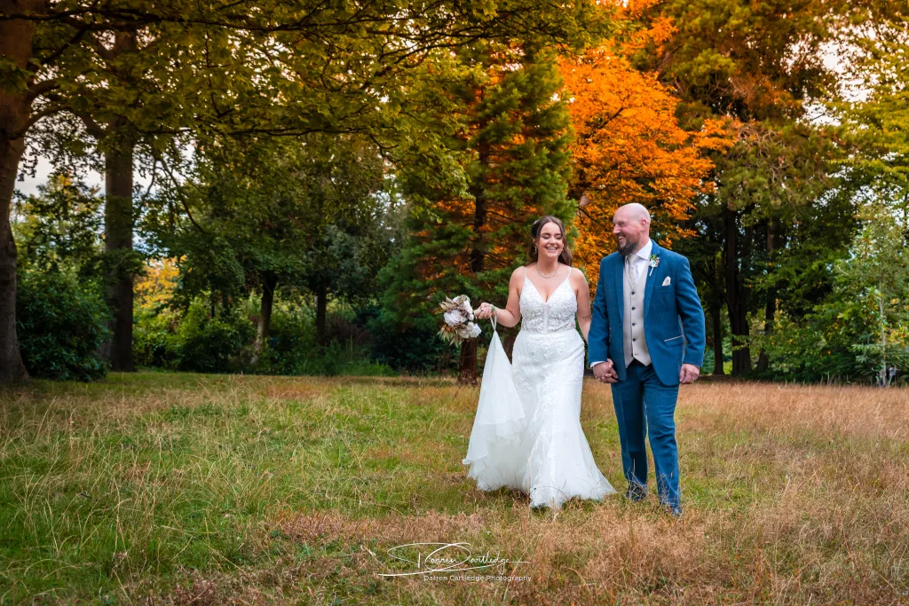 Couple walking hand in hand during a wedding in Yorkshire