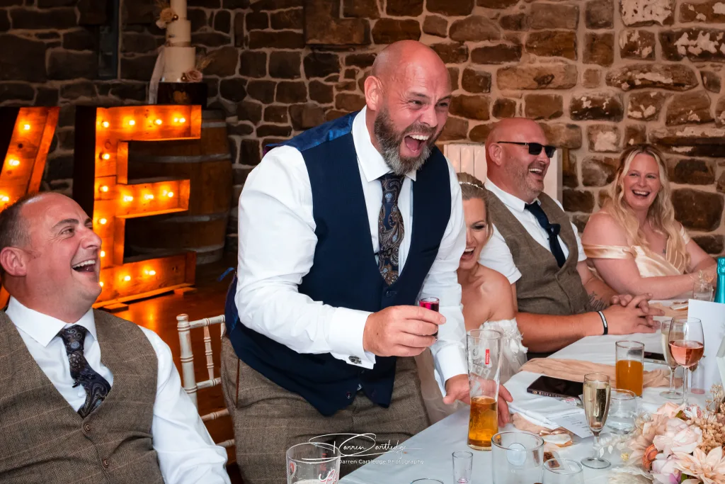 Groom taking a shot during speeches at a Yorkshire wedding