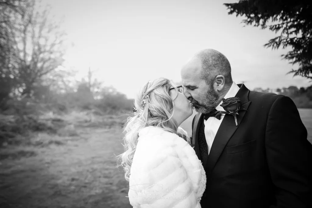 Couple sharing a kiss at The Old Barn at Esholt wedding venue in Yorkshire