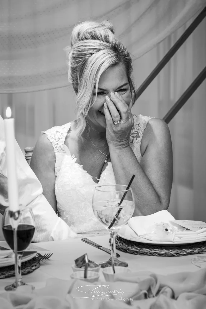 Bride laughing during a speech at Willerby Barn wedding in East Yorkshire